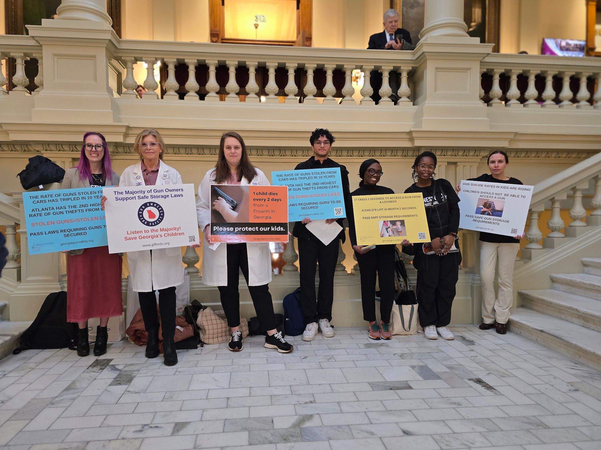 Volunteers holding signs